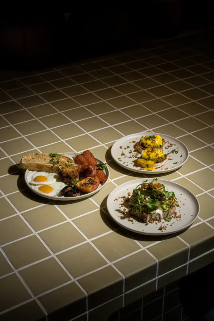 Breakfast spread of three plates on green tile counter at Dawn cafe Lago Nusa Lembongan