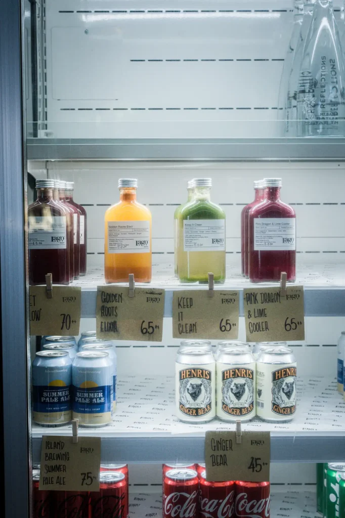 Lago cold-press juice bottles and craft beer in the fridge at Dawn cafe Nusa Lembongan