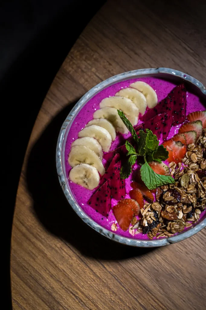 Dragonfruit smoothie bowl with banana, granola, strawberry and mint at Dawn cafe Lago Nusa Lembongan