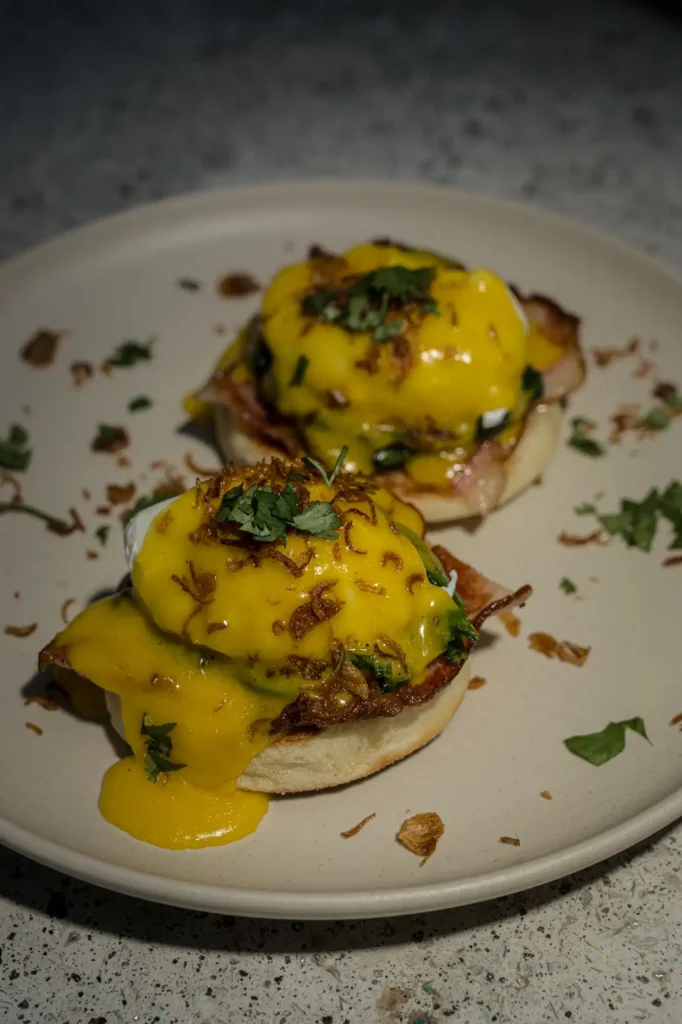 Eggs Benedict with crispy shallots and coriander on muffin at Dawn cafe Lago Nusa Lembongan
