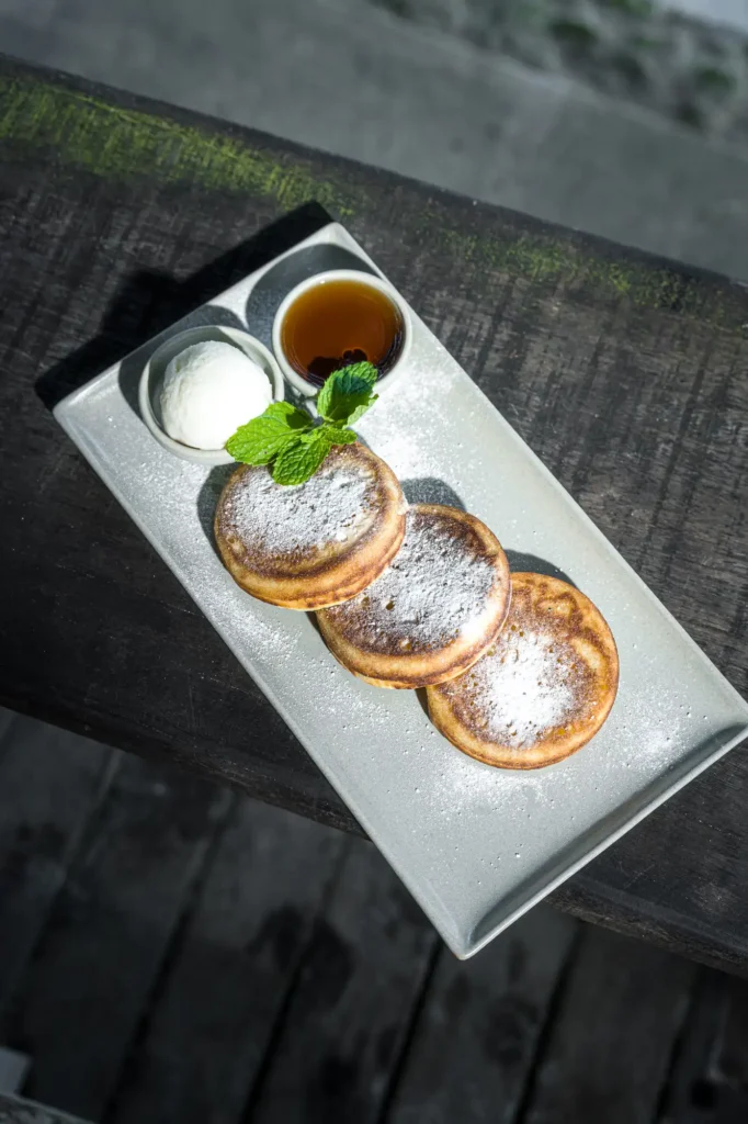 Japanese-style fluffy pancakes with icing sugar, cream and syrup at Dawn cafe Lago Nusa Lembongan
