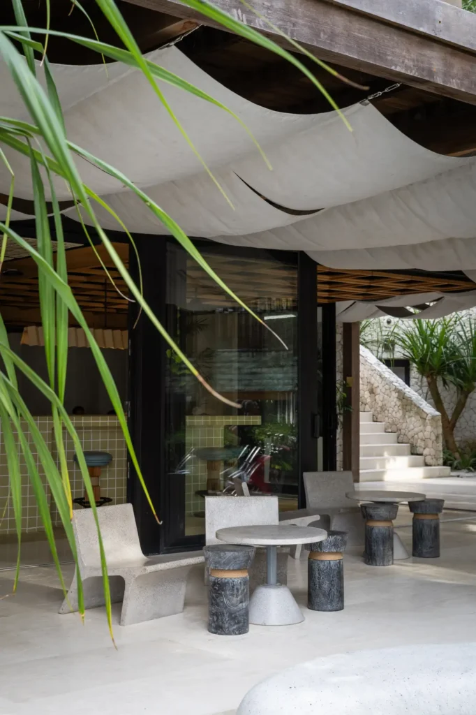Outdoor seating under draped canvas canopy with terrazzo chairs at Dawn cafe Lago Nusa Lembongan
